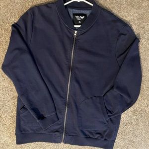 Navy blue zip up jacket. Size is XL but really fits like a M.